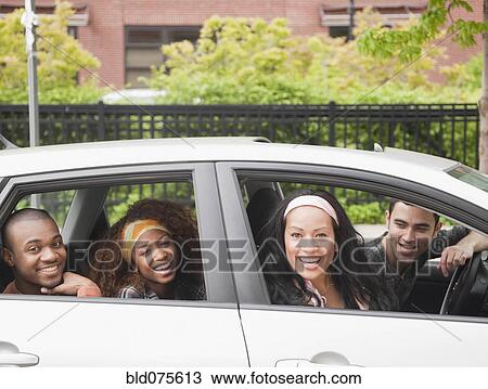 Stock Image - Friends riding in car. Fotosearch