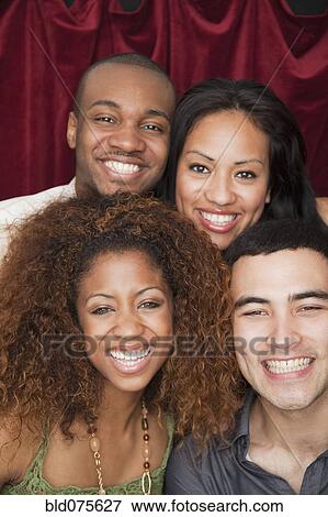 Friends smiling in photo booth View Large Photo Image Stock Photo - Friends smiling in photo booth. Fotosearch