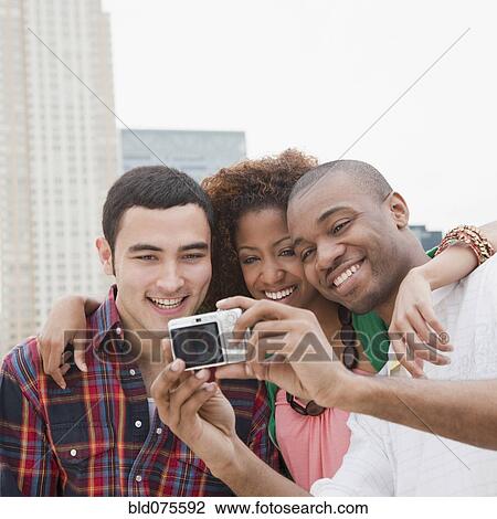 Stock Image - Friends taking self-portrait. Fotosearch