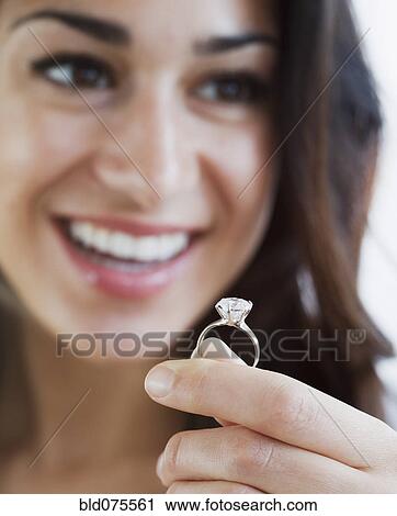 Hispanic woman holding engagement ring View Large Photo Image Stock Image - Hispanic woman holding engagement ring. Fotosearch