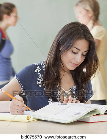 Hispanic woman studying in classroom View Large Photo Image Stock Image - Hispanic woman studying in classroom. Fotosearch