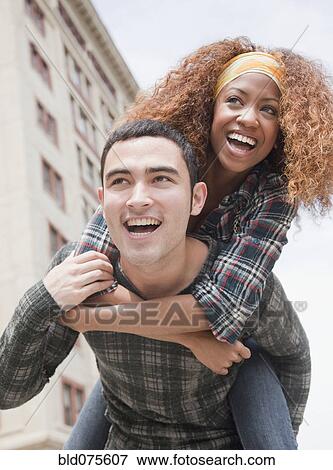 Man piggybacking woman View Large Photo Image Stock Photo - Man piggybacking woman. Fotosearch