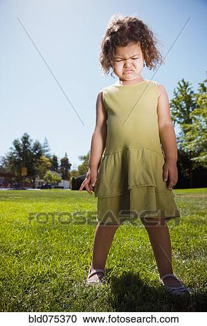 Stock Image - Mixed race girl crying in park. Fotosearch
