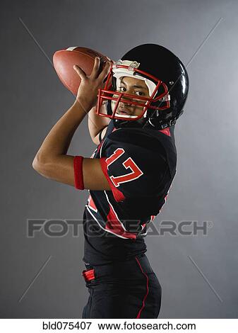 Mixed race quarterback ready to throw football View Large Photo Image Stock Photo - Mixed race quarterback ready to throw football. Fotosearch
