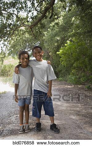 African boy and girl hugging on dirt road View Large Photo Image Stock Photo - African boy and girl hugging on dirt road. Fotosearch