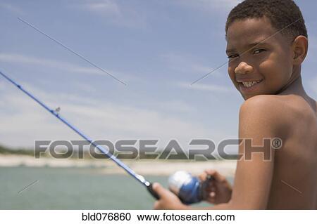Stock Image - African boy fishing. Fotosearch