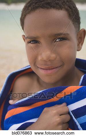 African boy wrapped in beach towel View Large Photo Image Stock Image - African boy wrapped in beach towel. Fotosearch