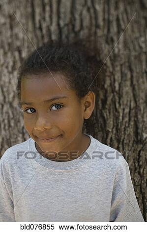African girl leaning against tree View Large Photo Image Stock Photography - African girl leaning against tree. Fotosearch