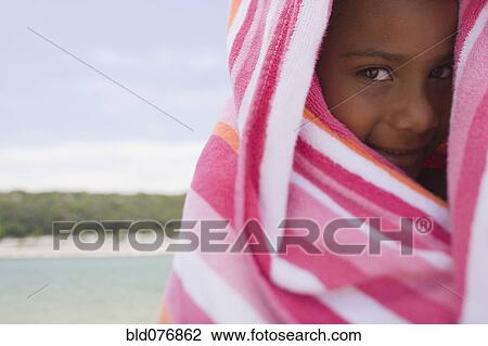 African girl wrapped in beach towel View Large Photo Image Stock Image - African girl wrapped in beach towel. Fotosearch