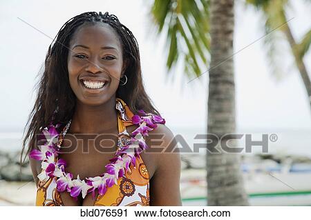 African woman wearing lei on beach View Large Photo Image Stock Image - African woman wearing lei on beach. Fotosearch