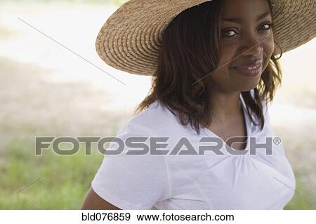 African woman wearing straw hat View Large Photo Image Stock Photo - African woman wearing straw hat. Fotosearch