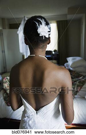 Stock Image - Back of African bride's wedding dress. Fotosearch
