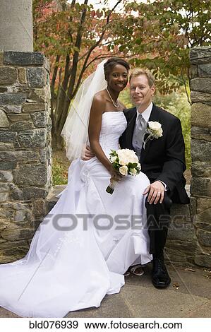 Bride sitting on groom's lap View Large Photo Image Stock Photo - Bride sitting on groom's lap. Fotosearch
