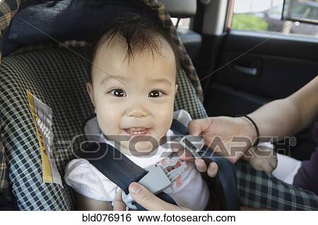Stock Photograph - Chinese baby in car seat. Fotosearch
