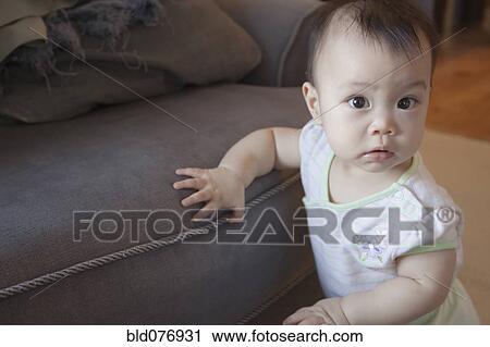 Chinese baby leaning against sofa View Large Photo Image Stock Image - Chinese baby leaning against sofa. Fotosearch