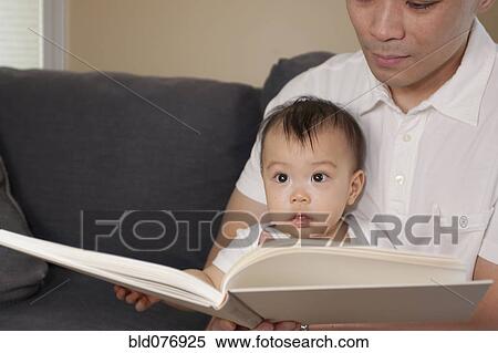 Chinese father and baby reading book on sofa View Large Photo Image Stock Photography - Chinese father and baby reading book on sofa. Fotosearch