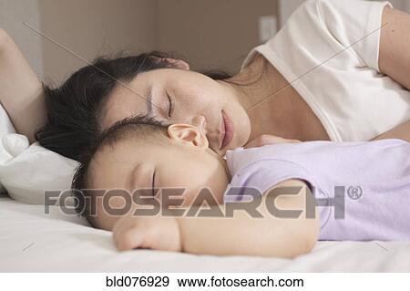 Stock Photo - Chinese mother and baby sleeping. Fotosearch