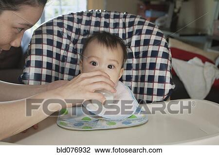Chinese mother feeding baby View Large Photo Image Stock Image - Chinese mother feeding baby. Fotosearch