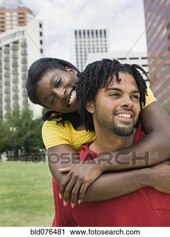 Couple hugging in urban park View Large Photo Image Stock Image - Couple hugging in urban park. Fotosearch