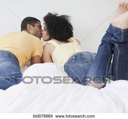 Couple kissing on bed View Large Photo Image Stock Photography - Couple kissing on bed. Fotosearch