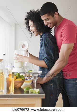 Couple mixing margaritas in kitchen View Large Photo Image Stock Image - Couple mixing margaritas in kitchen. Fotosearch