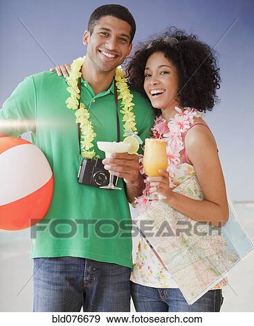 Couple on beach with tropical drinks View Large Photo Image Stock Photo - Couple on beach with tropical drinks. Fotosearch