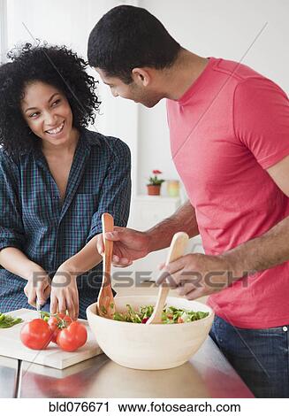 Couple preparing salad View Large Photo Image Stock Image - Couple preparing salad. Fotosearch
