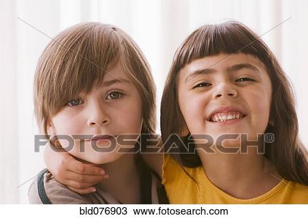 Stock Image - Hispanic boy and girl hugging. Fotosearch