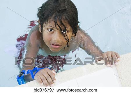 Stock Photo - Hispanic boy in swimming pool. Fotosearch