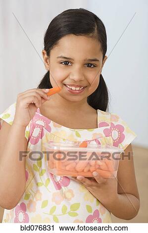 Hispanic girl eating carrots View Large Photo Image Stock Image - Hispanic girl eating carrots. Fotosearch