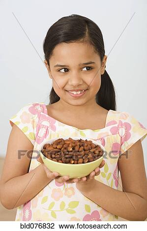 Hispanic girl holding bowl of almonds View Large Photo Image Stock Image - Hispanic girl holding bowl of almonds. Fotosearch