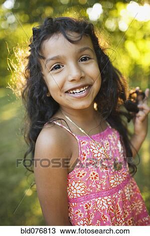 Stock Image - Hispanic girl smiling. Fotosearch