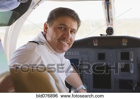 Hispanic pilot in cockpit View Large Photo Image Stock Photograph - Hispanic pilot in cockpit. Fotosearch