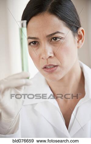 Hispanic scientist holding vial of liquid View Large Photo Image Stock Photo - Hispanic scientist holding vial of liquid. Fotosearch