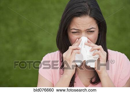 Hispanic woman blowing nose View Large Photo Image Stock Image - Hispanic woman blowing nose. Fotosearch