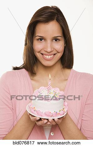 Hispanic woman holding birthday cake View Large Photo Image Stock Photo - Hispanic woman holding birthday cake. Fotosearch