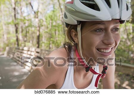 Stock Photography - Hispanic woman wearing bike helmet. Fotosearch