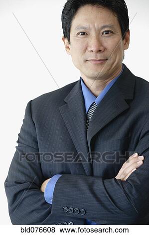 Stock Photo - Japanese businessman with arms crossed. Fotosearch