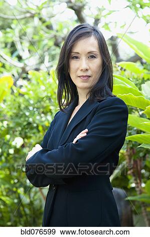 Japanese businesswoman with arms crossed View Large Photo Image Stock Photo - Japanese businesswoman with arms crossed. Fotosearch