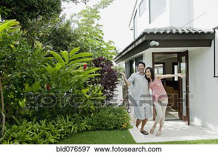 Japanese couple smiling on patio View Large Photo Image Stock Photo - Japanese couple smiling on patio. Fotosearch