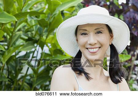 Stock Image - Japanese woman wearing hat. Fotosearch