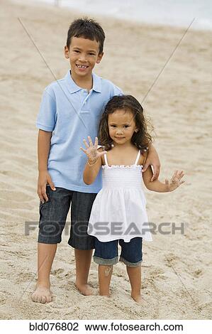 Mixed race brother and sister on beach View Large Photo Image Stock Image - Mixed race brother and sister on beach. Fotosearch
