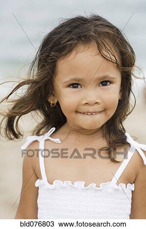 Mixed race girl smiling on beach View Large Photo Image Stock Image - Mixed race girl smiling on beach. Fotosearch