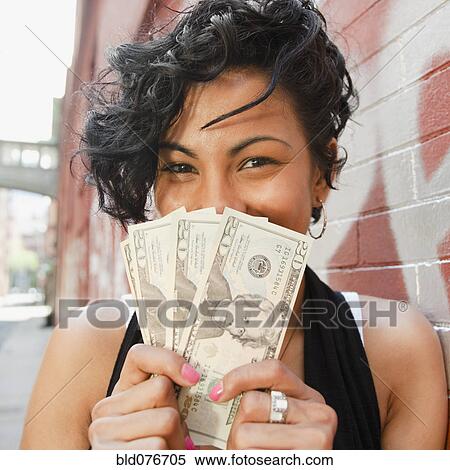 Mixed race woman holding twenty dollar bills View Large Photo Image Stock Photography - Mixed race woman holding twenty dollar bills. Fotosearch
