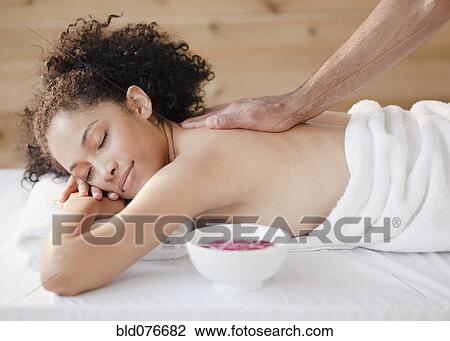 Mixed race woman receiving massage View Large Photo Image Stock Image - Mixed race woman receiving massage. Fotosearch
