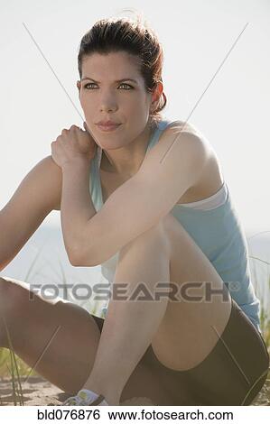 Mixed race woman sitting on beach View Large Photo Image Stock Photograph - Mixed race woman sitting on beach. Fotosearch