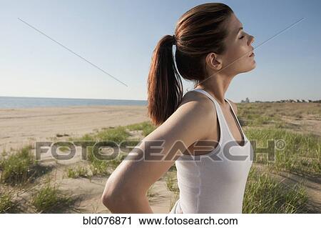 Mixed race woman standing on beach with eyes closed View Large Photo Image Stock Image - Mixed race woman standing on beach with eyes closed. Fotosearch