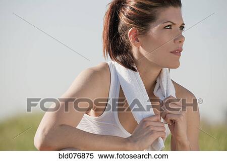Stock Photography - Mixed race woman with towel around neck. Fotosearch