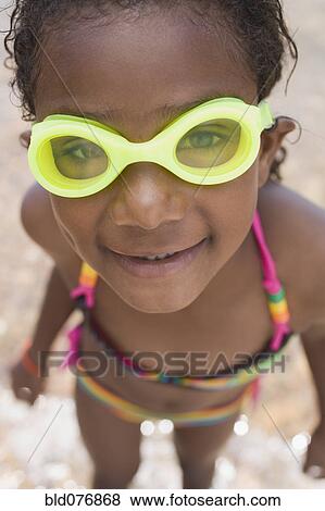 Stock Photo - Smiling African girl wearing goggles and bikini. Fotosearch