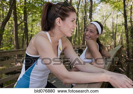 Stock Image - Women in sportswear on bridge. Fotosearch